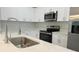 Close-up of a kitchen featuring a stainless steel sink, quartz countertops, and stainless steel appliances at 14222 Sw 48Th Ave Rd, Ocala, FL 34473