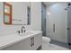 Sleek bathroom with a modern vanity, black hardware, and a glass-enclosed shower for a luxurious experience at 14645 Isleview Dr, Winter Garden, FL 34787