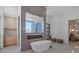 Contemporary bathroom with a freestanding tub, walk-in shower, and wood cabinetry at 14645 Isleview Dr, Winter Garden, FL 34787