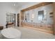 Luxurious bathroom featuring dual vanities, a soaking tub, and plenty of storage at 14645 Isleview Dr, Winter Garden, FL 34787