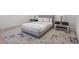 Neutral bedroom with modern furniture, a plush rug, and ample space, complemented by stylish decor at 14645 Isleview Dr, Winter Garden, FL 34787