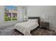 Bright bedroom with large windows offering views and a comfortable bed with stylish bedside tables at 14645 Isleview Dr, Winter Garden, FL 34787