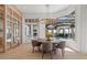Elegant dining room featuring a modern chandelier, a large window with pool view, and hardwood floors at 14645 Isleview Dr, Winter Garden, FL 34787