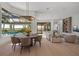 Bright dining room with large windows, modern chandelier, and views of the pool at 14645 Isleview Dr, Winter Garden, FL 34787