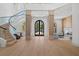 Bright foyer showcasing a winding staircase and custom millwork at 14645 Isleview Dr, Winter Garden, FL 34787