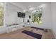 Bright home gym with mirrors, a window overlooking lush greenery, and space for exercise equipment at 14645 Isleview Dr, Winter Garden, FL 34787