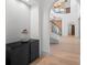 Hallway featuring white walls, hardwood floors, and decorative accents at 14645 Isleview Dr, Winter Garden, FL 34787
