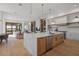 Open-concept kitchen with large marble island, stainless steel appliances, and hardwood floors at 14645 Isleview Dr, Winter Garden, FL 34787