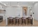 Bright kitchen features waterfall island, modern cabinets, wood accents, and pendant lighting at 14645 Isleview Dr, Winter Garden, FL 34787