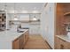 Gourmet kitchen with modern appliances, light wood flooring, and ample counter space at 14645 Isleview Dr, Winter Garden, FL 34787