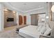 Well-lit primary bedroom featuring hardwood floors, accent wall, and a large bed at 14645 Isleview Dr, Winter Garden, FL 34787