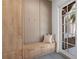 Mud room with built-in bench, storage cabinets, hooks, and a neutral color palette for functionality at 14645 Isleview Dr, Winter Garden, FL 34787