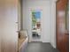 Mud room entrance featuring bench with cushion, storage cabinets, and hooks for organization and style at 14645 Isleview Dr, Winter Garden, FL 34787