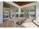 Covered patio with an outdoor dining area perfect for entertaining with multiple glass door entries at 14645 Isleview Dr, Winter Garden, FL 34787