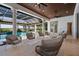 Inviting covered patio with comfortable seating, ceiling fans, and a view of the sparkling pool at 14645 Isleview Dr, Winter Garden, FL 34787