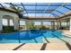 Beautiful pool area that has lush landscaping and breathtaking views of the water beyond at 14645 Isleview Dr, Winter Garden, FL 34787