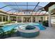 An expansive pool and spa area with lush landscaping and a screened enclosure at 14645 Isleview Dr, Winter Garden, FL 34787