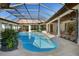 Screened-in pool with stone deck, seating area, and view of the house at 14645 Isleview Dr, Winter Garden, FL 34787