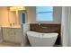 Stylish bathroom with a freestanding tub, wood accent wall, and a double vanity at 15369 Sw 60Th Cir, Ocala, FL 34473