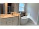 Bright bathroom with a soaking tub, modern vanity, and quartz countertops at 15369 Sw 60Th Cir, Ocala, FL 34473
