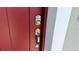 Inviting red front door with modern digital keypad and sleek handle at 15369 Sw 60Th Cir, Ocala, FL 34473