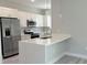 Stylish kitchen featuring white cabinets, stainless appliances, and quartz island at 15369 Sw 60Th Cir, Ocala, FL 34473