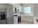 Modern kitchen with white cabinets, stainless appliances, and quartz countertops at 15369 Sw 60Th Cir, Ocala, FL 34473