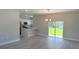 Bright and airy living room featuring a modern chandelier and an open layout to the kitchen at 15369 Sw 60Th Cir, Ocala, FL 34473