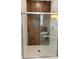 Luxurious walk-in shower with a glass enclosure, wood-look tile, and a rain shower head at 15369 Sw 60Th Cir, Ocala, FL 34473