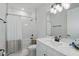 Bright bathroom with a shower-tub combo, white tile, and a modern vanity at 16008 Volterra Pt, Montverde, FL 34756