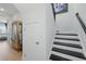 Hallway showcasing a staircase and storage solutions, with views to the bedroom at 16008 Volterra Pt, Montverde, FL 34756