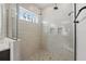 Walk-in shower with mosaic tile floor, glass door, and built in bench at 16008 Volterra Pt, Montverde, FL 34756