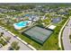 Community aerial view showcases tennis courts, the pool, ponds with fountains, and well-maintained landscaping at 16084 Black Hickory Dr, Winter Garden, FL 34787