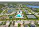 Wonderful aerial view highlighting community amenities: pool, tennis courts, playground, ponds, and clubhouse at 16084 Black Hickory Dr, Winter Garden, FL 34787