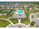 Stunning aerial view of the community pool, clubhouse, and amenities, with lush landscaping and ample parking at 16084 Black Hickory Dr, Winter Garden, FL 34787