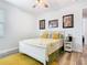 Bright bedroom features a white bed frame, floral bedding, wood-look floors, and cheerful decor at 16084 Black Hickory Dr, Winter Garden, FL 34787