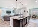 Beautiful kitchen featuring a granite island with seating that connects to a living and dining space at 16084 Black Hickory Dr, Winter Garden, FL 34787