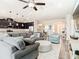 Open-concept living room flowing into the kitchen with stainless steel appliances and lots of cabinets at 16084 Black Hickory Dr, Winter Garden, FL 34787