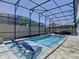 Sparkling pool with lounge chairs under a screened enclosure; providing a relaxing outdoor oasis at 16084 Black Hickory Dr, Winter Garden, FL 34787