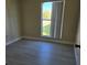 A bright bedroom with a window offering natural light and neutral walls at 1864 Caralee Blvd # 3, Orlando, FL 32822