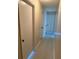 Neutral colored hallway with three doors at 1864 Caralee Blvd # 3, Orlando, FL 32822