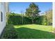 Lush green backyard featuring mature landscaping and a tidy lawn at 2090 Common Way Rd, Orlando, FL 32814