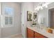 Bright bathroom with a window, a toilet, and a vanity with a mirror, exuding simple elegance at 2090 Common Way Rd, Orlando, FL 32814