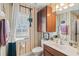 Bright bathroom featuring a vanity with storage, a toilet, and natural light from the window at 2090 Common Way Rd, Orlando, FL 32814