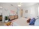 Cozy bedroom with carpet flooring, colorful decor, natural light from the window, and a ceiling fan at 2090 Common Way Rd, Orlando, FL 32814