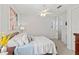 Bright bedroom with a comfortable bed, natural light, and a view into the hallway at 2090 Common Way Rd, Orlando, FL 32814