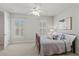 Bright bedroom with neutral walls, carpet, shuttered windows and a ceiling fan at 2090 Common Way Rd, Orlando, FL 32814