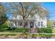 Charming two-story home features a welcoming front porch and a beautifully landscaped front yard at 2090 Common Way Rd, Orlando, FL 32814