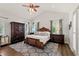 Large main bedroom featuring vaulted ceilings, hardwood floors, and abundant natural light at 2090 Common Way Rd, Orlando, FL 32814