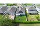 Aerial shot showcasing the backyard with pergola, playground, solar panels, and fenced yard at 2145 Rush Bay Way, Orlando, FL 32824